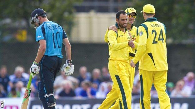 Scotland's Calum MacLeod is put out by Fawad Ahmed (2nd left).