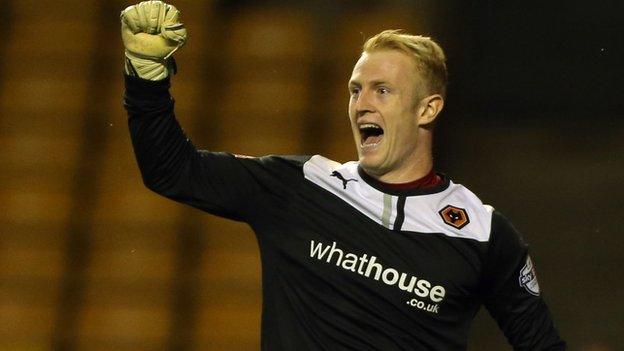 Wolves keeper Aaron McCarey celebrates one of his two penalty saves against his old club Walsall