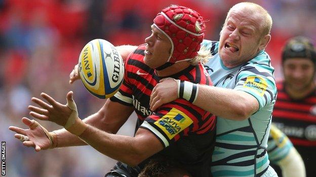 Saracens lock Mouritz Botha is tackled by Leicester prop Dan Cole