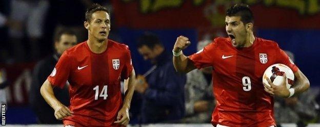 Serbia's Aleksandar Mitrovic (R) celebrates with teammate Nemanja Matic after scoring against Croatia