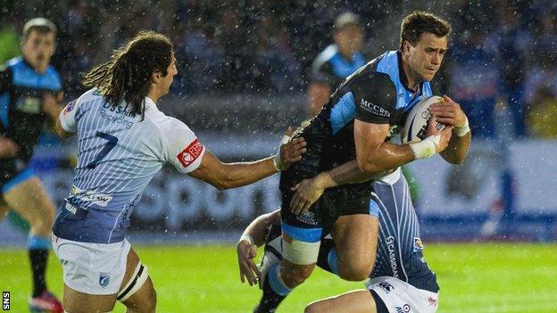 Glasgow Warriors' Alex Dunbar is tackled by Cardiff duo Josh Navidi and Gavin Evans