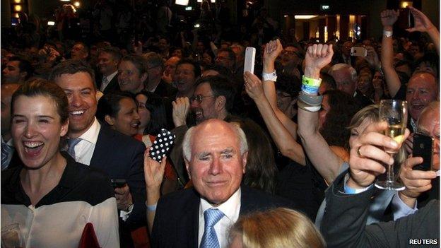 John Howard smiles as Australia's leader Tony Abbott claims victory at an election night function in Sydney, 7 September