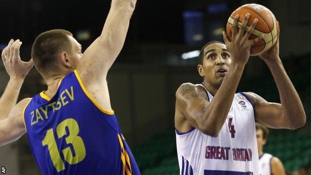 Britain's Kieron Achara, right, challenges for the ball with Ukraine's Ihor Zaytsev