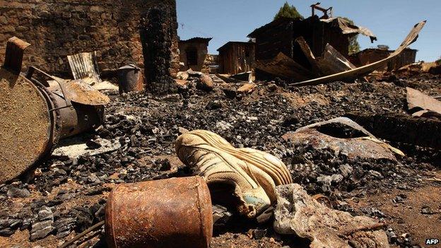 A child's shoe lies on the ground next to a burnt house in Komoyo on 6 January 2008 near Eldoret, Kenya