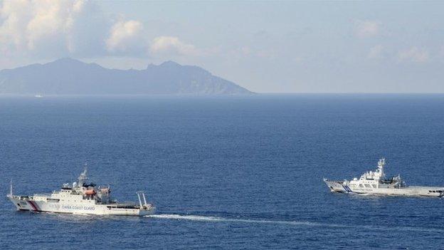 A China coast guard vessel, left, is followed by a Japan coast guard ship as it sailed near the disputed East China Sea islands called Senkaku by Japan and Diaoyu by China, 10 September 2013