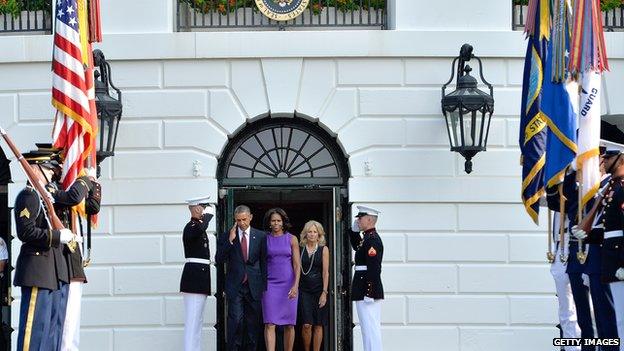 The Obamas leaving a building