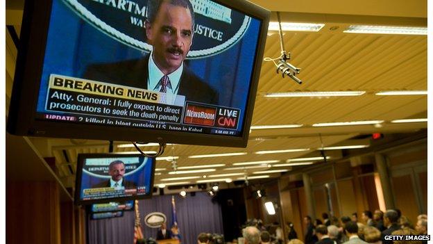 Television screen showing an image of Attorney General Eric Holder