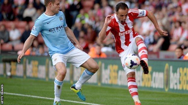 Manchester City's James Milner thwarts Stoke City's Matthew Etherington