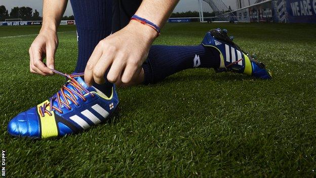 Footballer lacing up