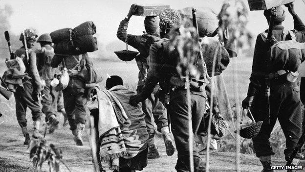 December 1971: An elderly Pakistani refugee is pushed aside by Indian troops advancing into the East Pakistan (Bangladesh) area during the Indo-Pakistani war.