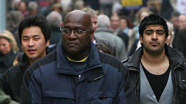 A busy street in London with people of several different ethnicities