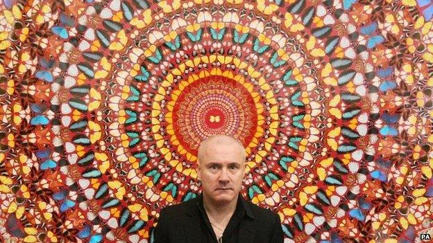 Artist Damien Hirst with his work "I Am Become Death, Shatterer of Worlds 2006", on display at Tate Modern art gallery in 2012