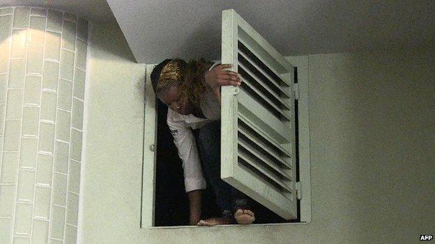 A woman climbing out of a hatch