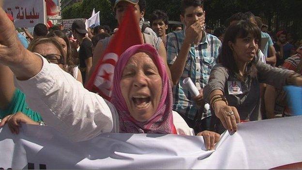 A woman gestures during an anti-government demonstration in Tunisian capital, Tunis.