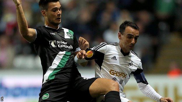 Leon Britton (right) in action against St Gallen's Goran Karanovic