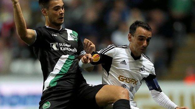 Leon Britton (right) in action against St Gallen's Goran Karanovic