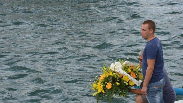 Fishermen prepare to drop flowers in sea near spot where ship sank off Lampedusa, Italy, 5 October