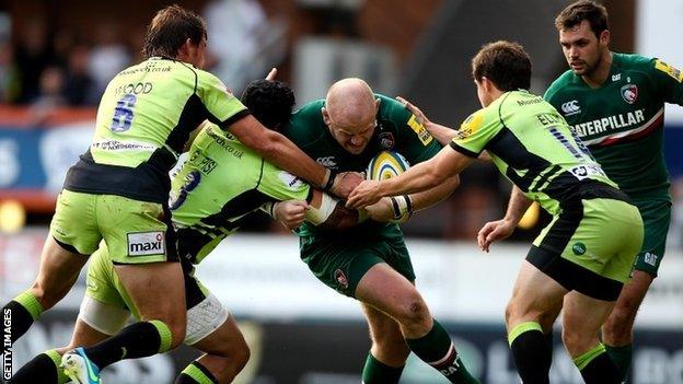 Leicester's Dan Cole is tackled by three Northampton players