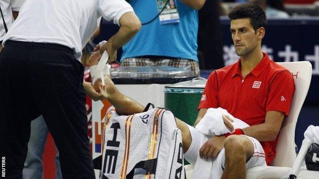 Novak Djokovic gets treatment for his injury in Shanghai