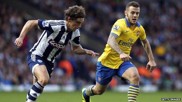 Arsenal's English midfielder Jack Wilshere runs with the ball in front of West Bromwich Albion's English defender Billy Jones.