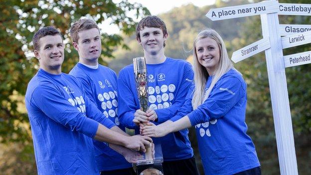 Scottish athletes Russell Weir, Marc Austin, Ross Murdoch and Beverly Campbell clutch the baton in Stirling before it journeys to India