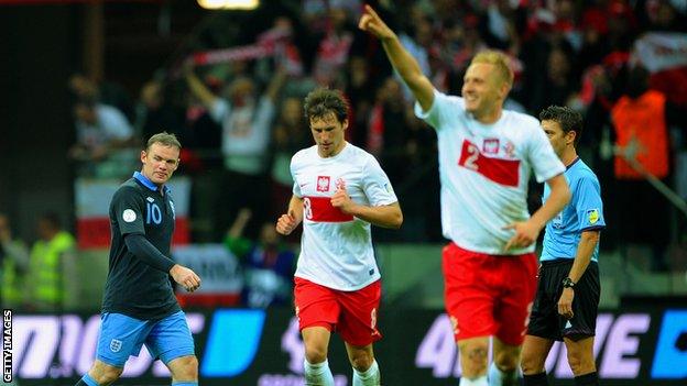 Wayne Rooney dejected as Poland celebrate