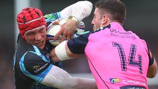 Exeter flanker Tom Johnson holds off Blues wing Alex Cuthbert