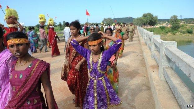 Hindu pilgrims walk on the bridge where a deadly stampede took place the previous day near the Ratangarh temple in the Datia district of central Madhya Pradesh on October 14, 2103