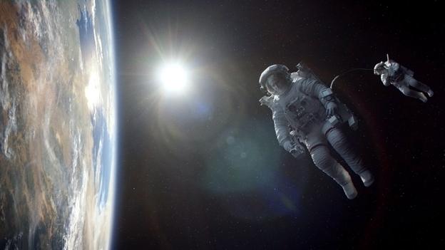 Movie still from Gravity showing George Clooney and Sandra Bullock floating in space