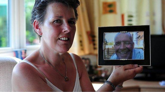 Tanya holds a picture of her husband Gary who was murdered by their son