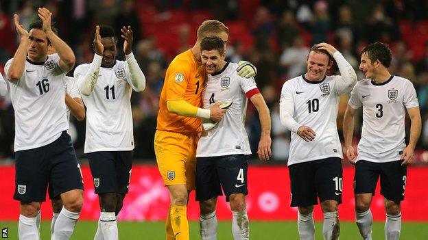 England players celebrate qualification for the 2014 World Cup in Brazil