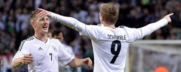 Andre Schurrle celebrates a goal with Bastian Schweinsteiger, who was winning his 100th cap