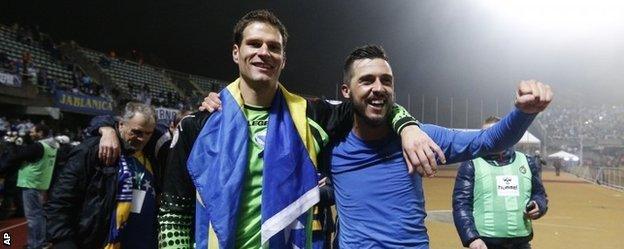 Asmir Begovic, left, and Haris Medunjanin celebrate Bosnia-Hercegovina's qualification