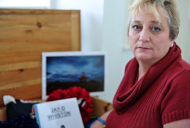 Caroline Shearer with a box of her son's treasured possessions, which is kept upstairs in her home