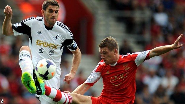 Swansea's Angel Rangel (left)