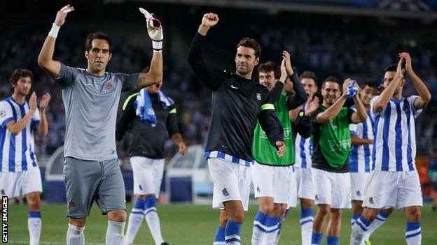 Real Sociedad players celebrating on the pitch following their 2nd leg win against Lyon