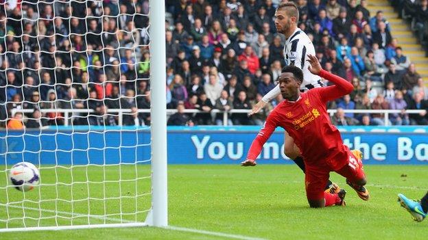 Liverpool striker Daniel Sturridge heads in a goal against Newcastle