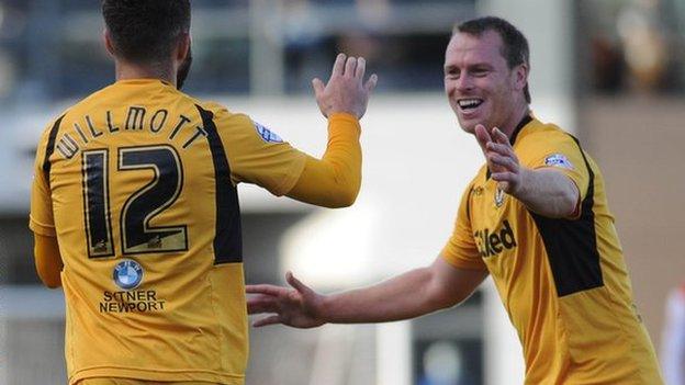 Robbie Willmott and Michael Flynn celebrate Newport's third goal