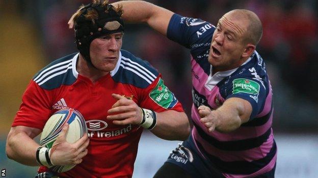 Munster's Niall Ronan is tackled by Gloucester Mike Tindall