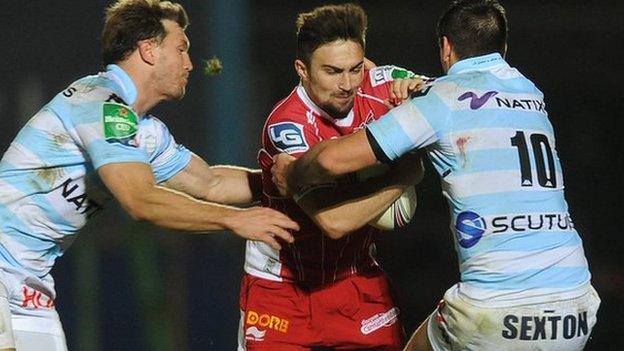 Scarlets' Jordan Williams is tackled by Jonathan Sexton