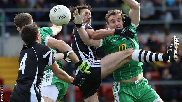 Burren's Eoin McCartan competes against Aidan Branagan of Kilcoo