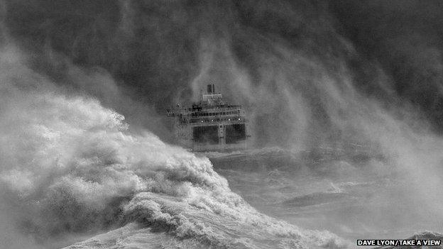 Ferry leaving Newhaven harbour in storm, East Sussex, by David Lyon