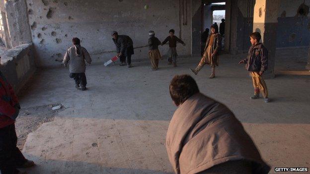 Afghan refugee boys play cricket at a refugee camp in Kabul in 2005