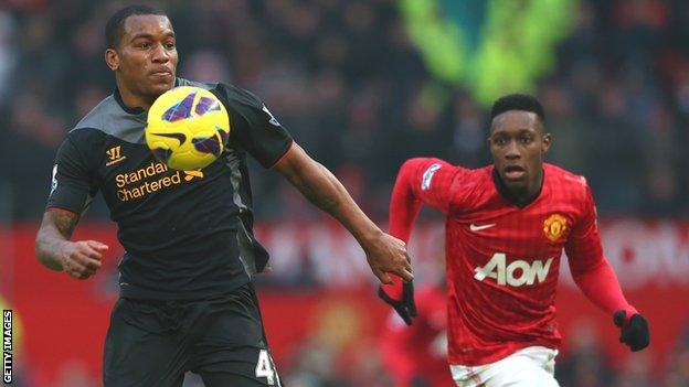 Liverpool's Andre Wisdom shields possession from Manchester United's Danny Wellbeck