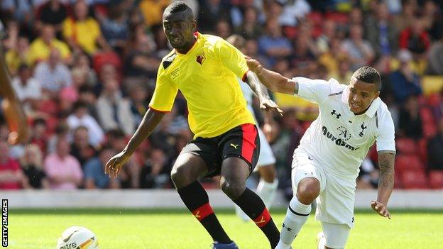 Watford's Prince Buaben (left) grapples with Spurs' Jermaine Jenas