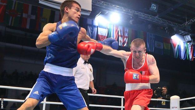 Jasurbek Latipov evades a punch from Paddy Barnes