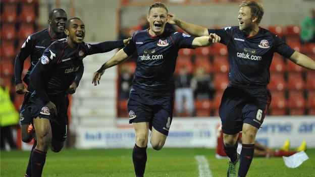 Craig Westcarr, Ashley Hemmings and Nicky Featherstone help celebrate Walsall midfielder Sam Mantom's goal at Swindon