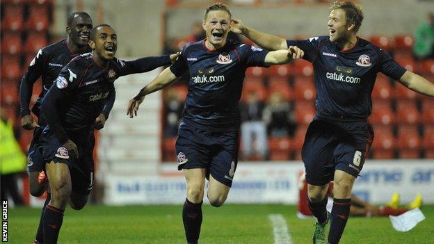 Craig Westcarr, Ashley Hemmings and Nicky Featherstone help celebrate Walsall midfielder Sam Mantom's goal at Swindon