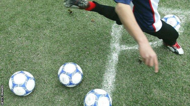 Footballer kicking a football