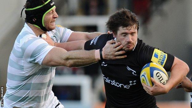 Adam Powell of Newcastle is tackled by London Irish's Ian Gough